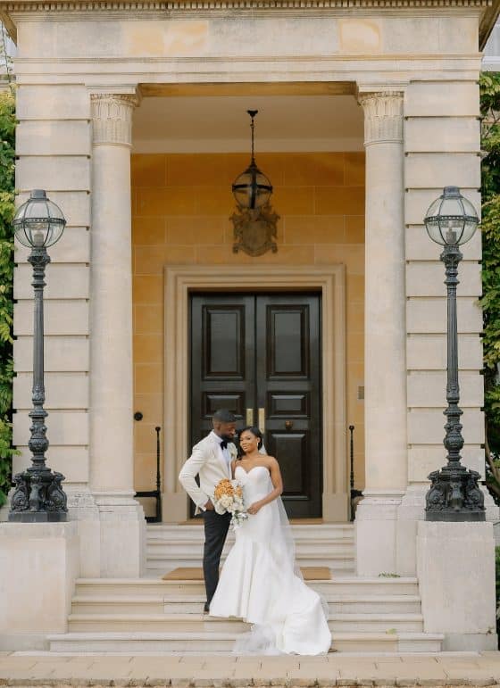 Afro-Caribbean bride and groom outside Hedsor House wedding venue
