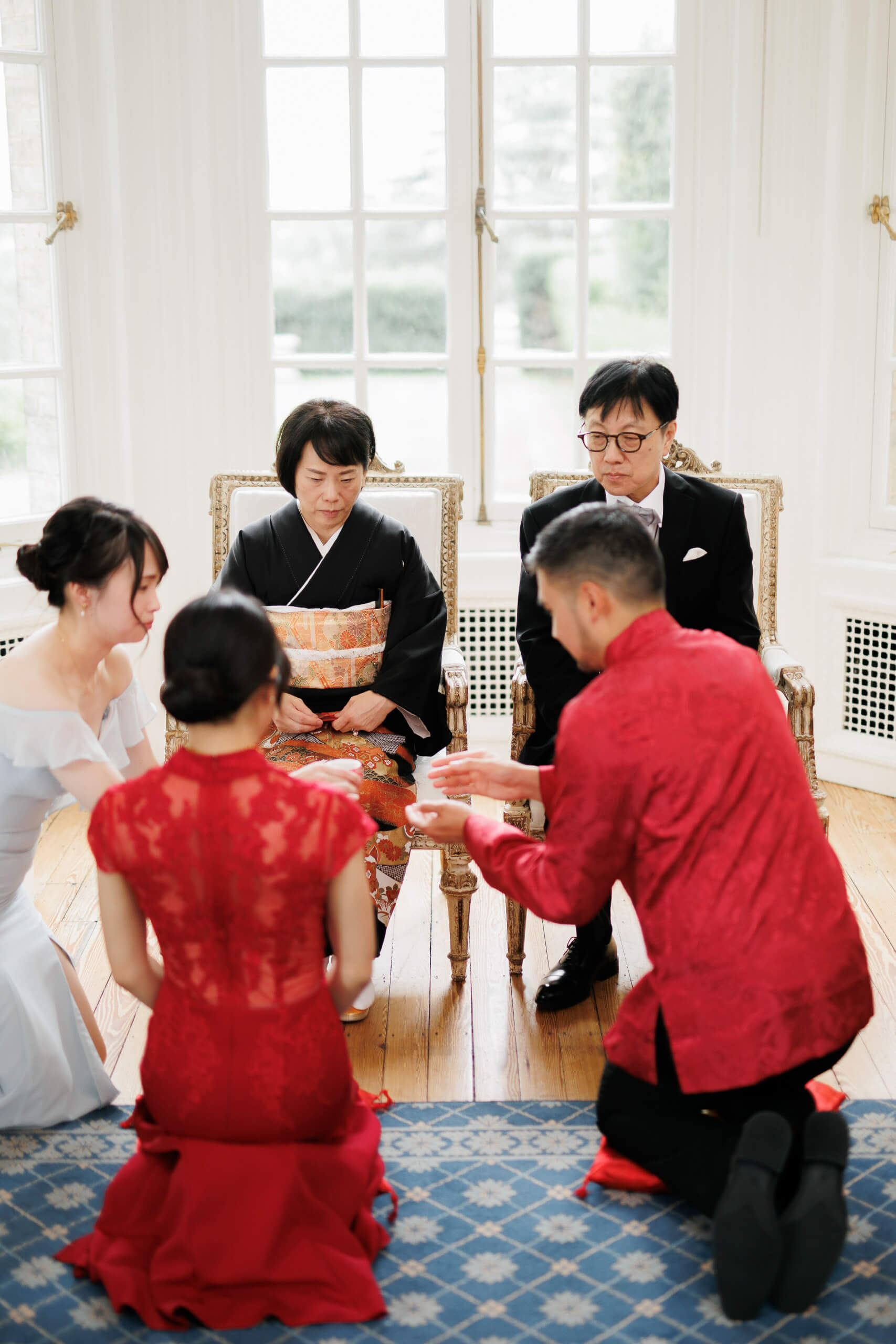bride and groom serve parents during chinese wedding tea ceremony